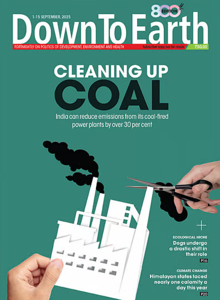 Magazine cover titled 'Down To Earth' with a graphic of cutting coal with scissors against a green background.