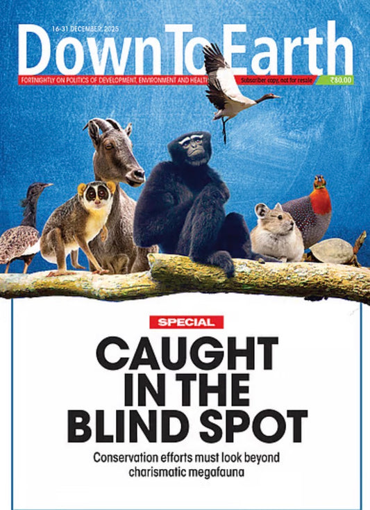 Cover of Down To Earth magazine featuring a collage of various animals on a tree branch under the headline "Caught in the Blind Spot".